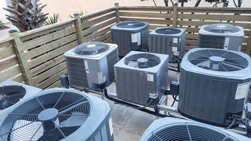 Row of residential air conditioning condensers serviced by Chicago HVAC Pros Corp